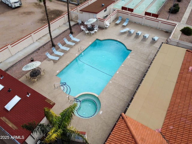 community pool featuring a patio, outdoor dining space, and fence