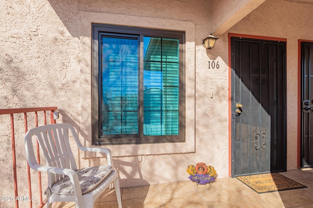 entrance to property with stucco siding