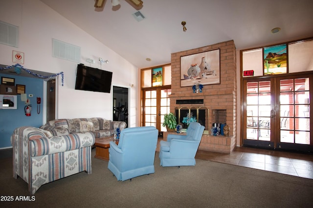 carpeted living area with french doors, a fireplace, visible vents, and tile patterned floors