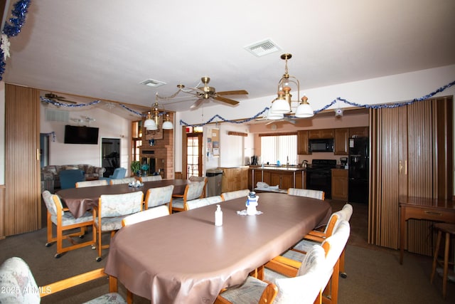 dining room with carpet floors, visible vents, and ceiling fan