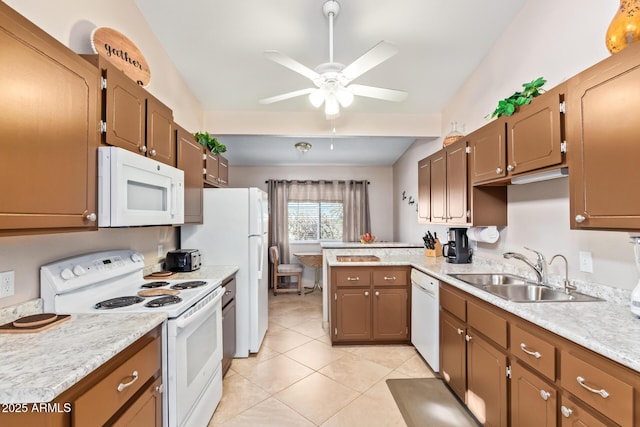 kitchen with white appliances, light tile patterned floors, a peninsula, light countertops, and a sink