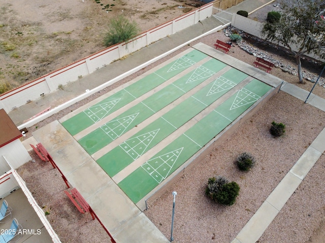 view of community featuring shuffleboard and fence