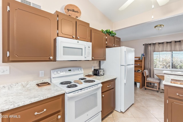 kitchen featuring white appliances, light tile patterned floors, ceiling fan, vaulted ceiling, and light countertops