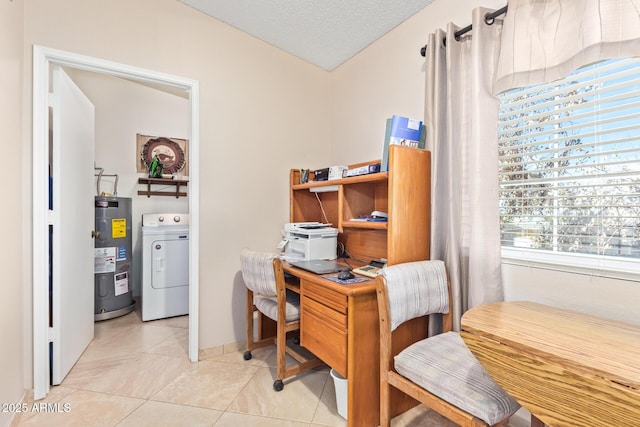 home office featuring water heater, light tile patterned floors, a textured ceiling, and washer / dryer