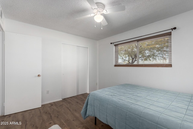 bedroom featuring ceiling fan, wood-type flooring, a closet, and a textured ceiling