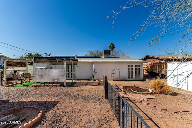 back of property with central air condition unit and french doors