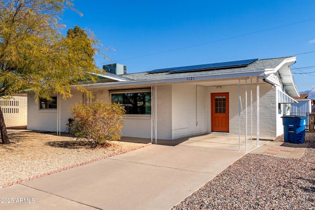 view of front of property featuring solar panels