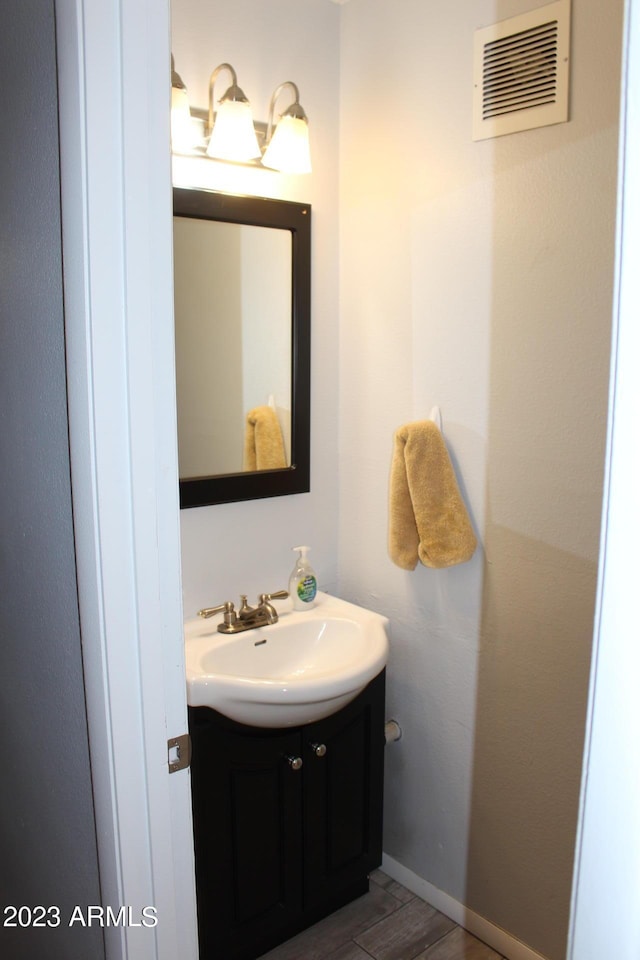 7120 E Wilshire Dr Unit 10, Scottsdale, AZ 85257 - bathroom featuring vanity, wood finished floors, and baseboards