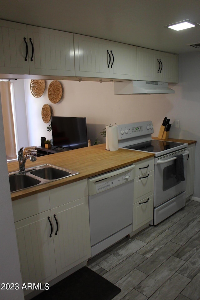 7120 E Wilshire Dr Unit 10, Scottsdale, AZ 85257 - kitchen featuring white appliances, under cabinet range hood, white cabinetry, and light wood-type flooring