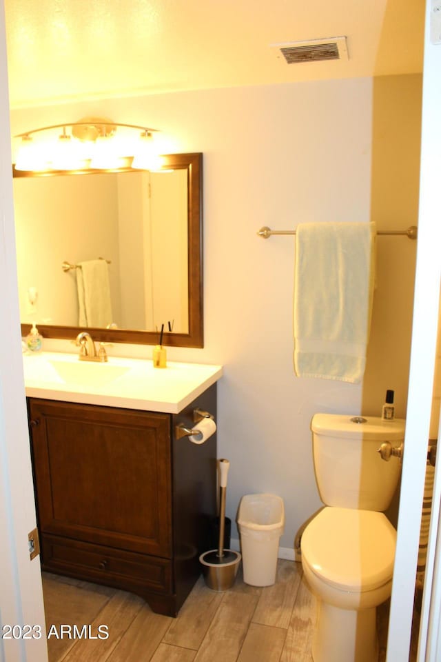 7120 E Wilshire Dr Unit 10, Scottsdale, AZ 85257 - bathroom featuring vanity, toilet, and wood finished floors