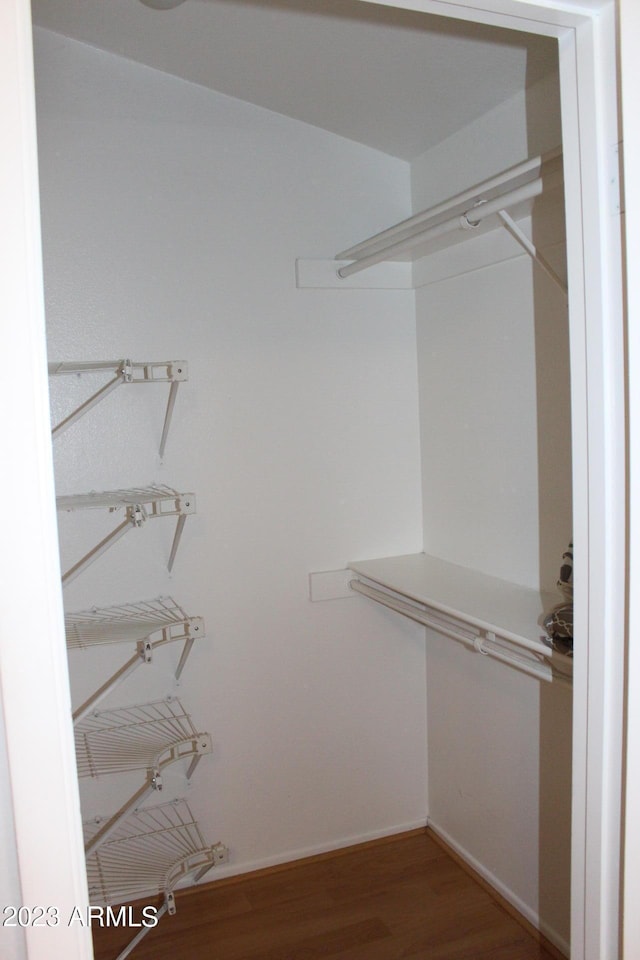 7120 E Wilshire Dr Unit 10, Scottsdale, AZ 85257 - walk in closet with wood finished floors