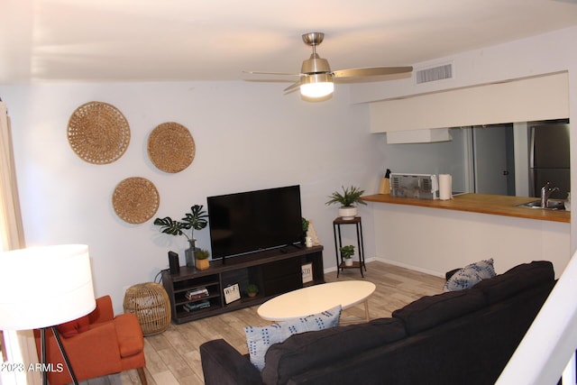 7120 E Wilshire Dr Unit 10, Scottsdale, AZ 85257 - living room featuring wood finished floors and a ceiling fan