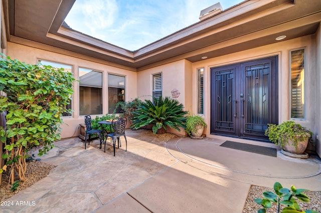 entrance to property with a patio area and french doors