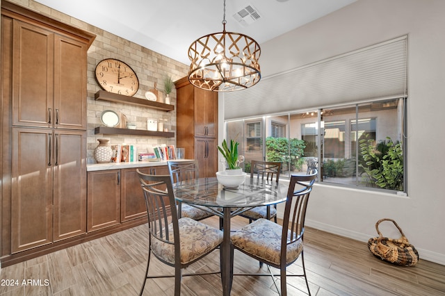 dining area featuring light hardwood / wood-style floors and an inviting chandelier