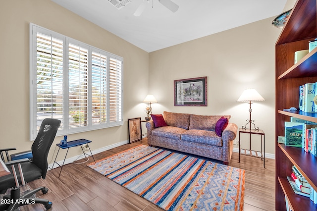 home office with hardwood / wood-style floors and ceiling fan