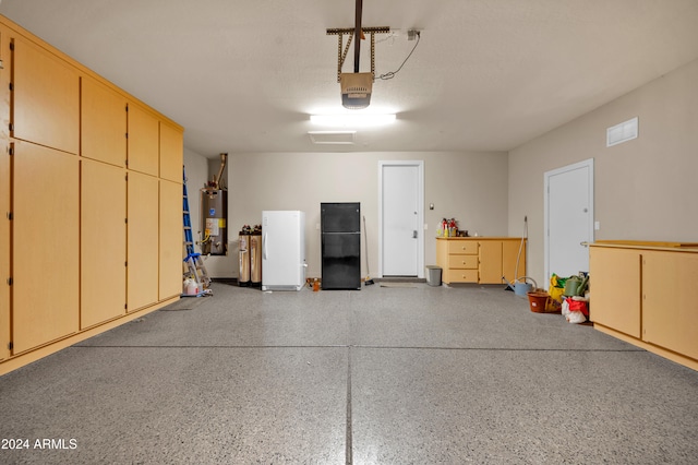 garage featuring black refrigerator, a garage door opener, gas water heater, and white refrigerator