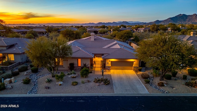 view of front of home with a mountain view and a garage