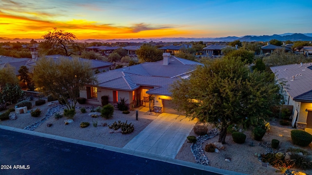 aerial view at dusk featuring a mountain view