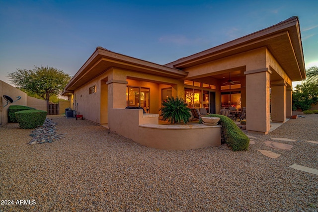 exterior space with ceiling fan, cooling unit, and a patio area