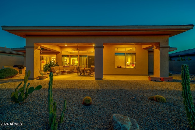 rear view of house featuring ceiling fan, an outdoor hangout area, and a patio