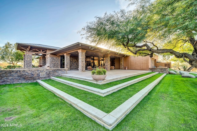 back of house featuring a yard and a patio