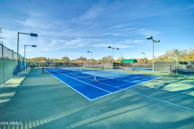 view of tennis court featuring basketball hoop