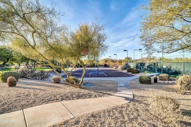 view of property's community featuring a water view and tennis court