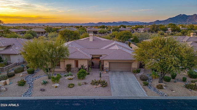 view of front of home featuring a mountain view and a garage