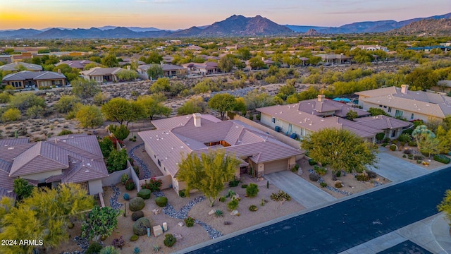 aerial view at dusk featuring a mountain view