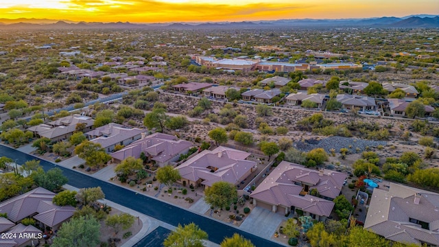 aerial view at dusk featuring a mountain view