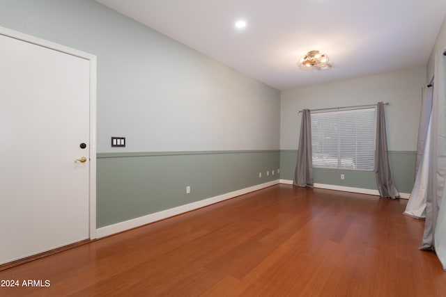 spare room featuring wood-type flooring