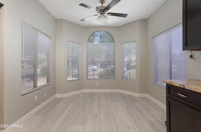 unfurnished dining area featuring light hardwood / wood-style flooring and ceiling fan