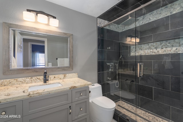 bathroom with a shower with door, toilet, and vanity