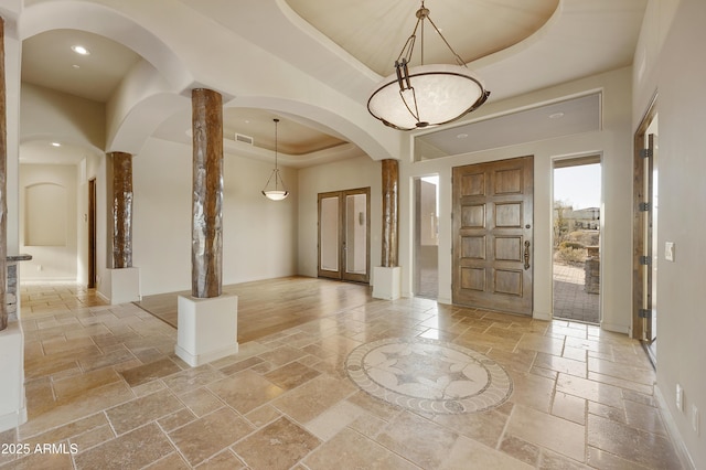 entryway with a raised ceiling