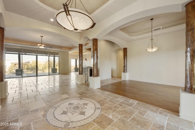 interior space featuring a tray ceiling and ceiling fan