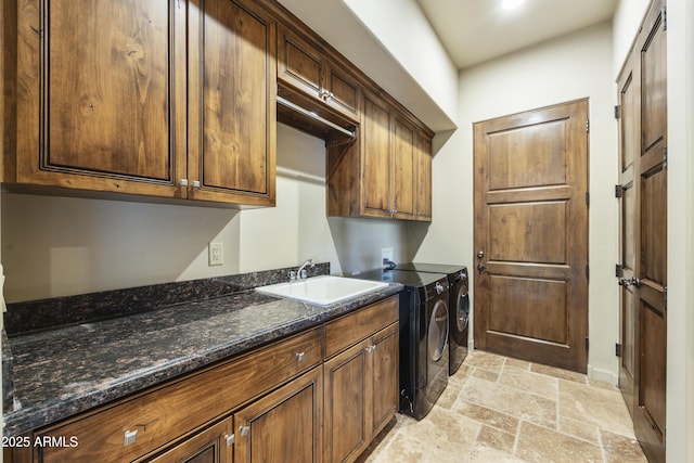 washroom featuring washer and dryer, cabinets, and sink