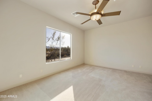 empty room with ceiling fan and light carpet