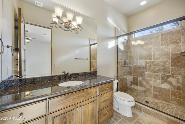 bathroom with toilet, vanity, ceiling fan with notable chandelier, and walk in shower