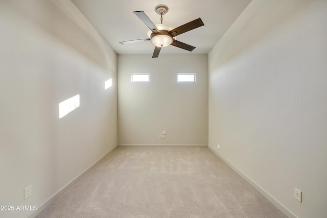 spare room featuring ceiling fan and light colored carpet