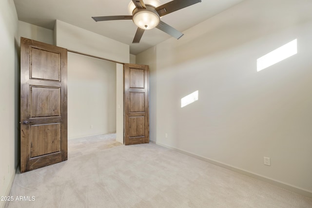 unfurnished bedroom featuring light carpet and ceiling fan