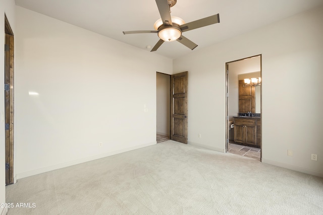 unfurnished bedroom featuring ensuite bath, ceiling fan, and light carpet