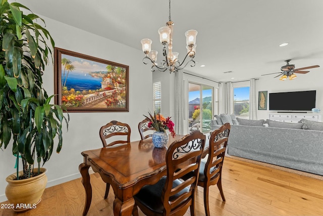 20701 W Minnezona Ave, Buckeye, AZ 85396 - dining area featuring ceiling fan with notable chandelier, light wood-style flooring, recessed lighting, and baseboards