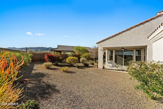 20701 W Minnezona Ave, Buckeye, AZ 85396 - view of yard with a patio area, a mountain view, a ceiling fan, and fence