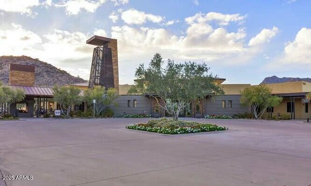 20701 W Minnezona Ave, Buckeye, AZ 85396 - view of front of property with metal roof, driveway, a chimney, and a standing seam roof