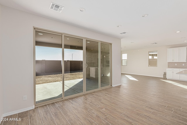 unfurnished room with light hardwood / wood-style flooring