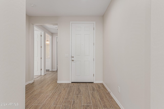 corridor with light wood-type flooring