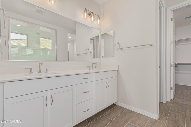 bathroom with vanity and a shower