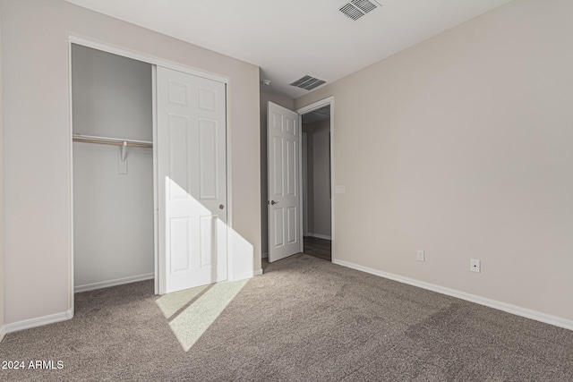 unfurnished bedroom with a closet and carpet