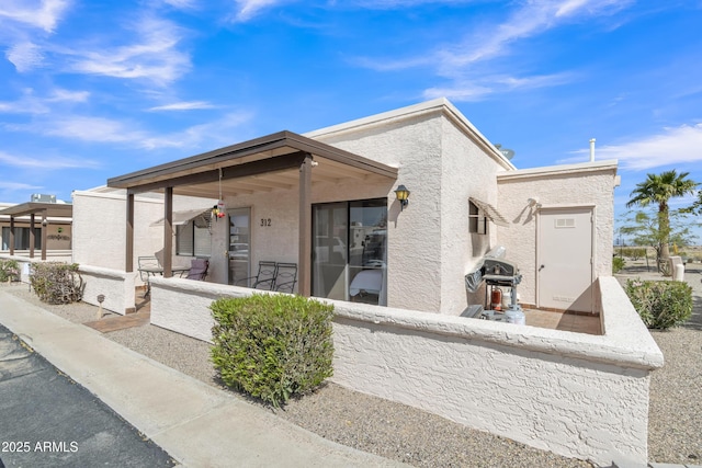 312 E Lancaster Ct, Florence, AZ 85132 - rear view of house with stucco siding and a porch