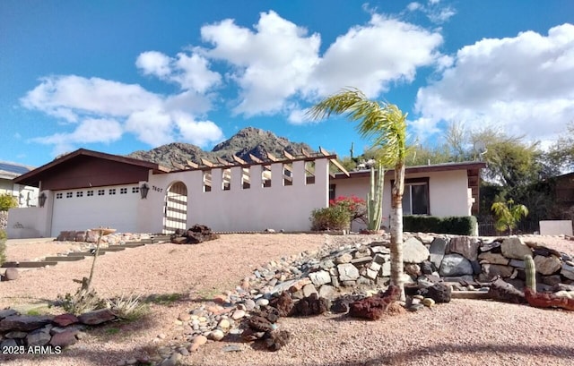 view of front of property with a garage and stucco siding